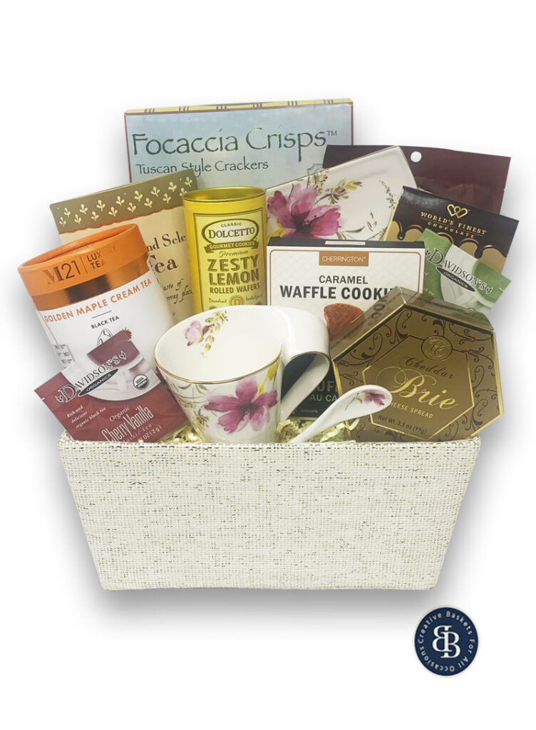 Gift basket for her with a floral teacup and spoon, loose leaf and organic teas, lemon wafers, waffle cookies and a brie spread